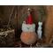 This image shows the Christmas gourd lit up with a battery-operated candle. It lights his happy face and snowflakes carved into the shell